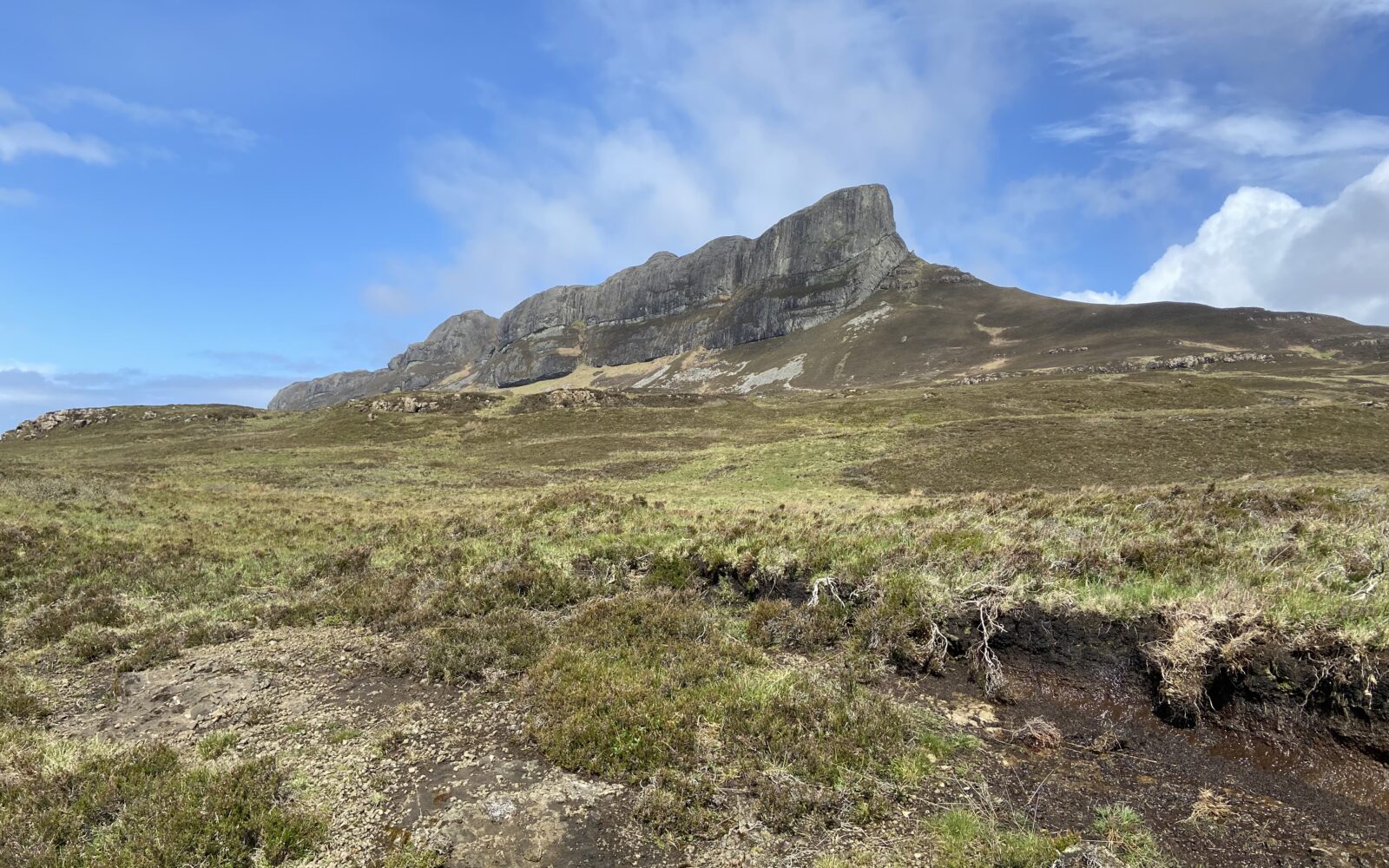 An Sgùrr, the highest point on the Isle of Eigg with blue skies beyond.